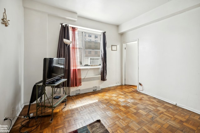 interior space featuring radiator, baseboards, and cooling unit