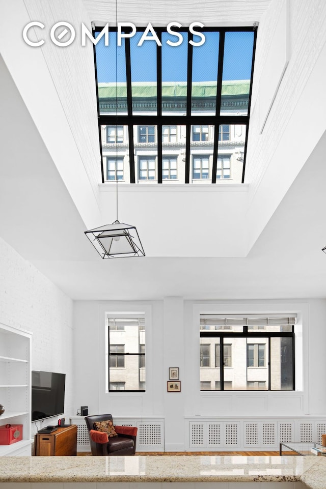 living area featuring a high ceiling and plenty of natural light