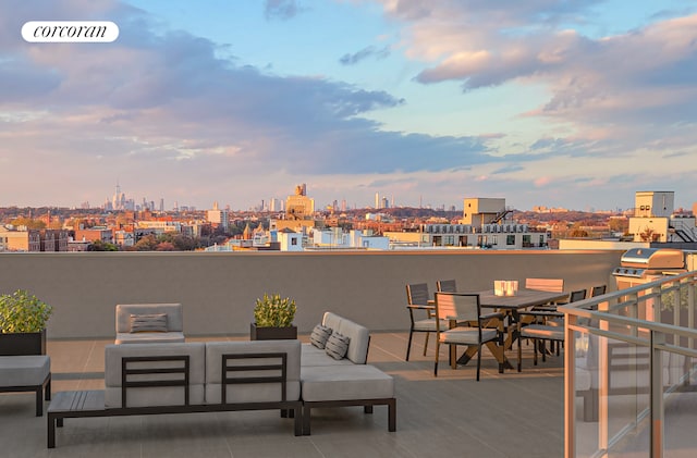 view of patio / terrace featuring a city view, an outdoor living space, a balcony, and visible vents