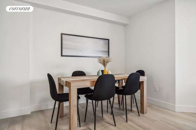 dining room with visible vents, baseboards, and light wood-style floors