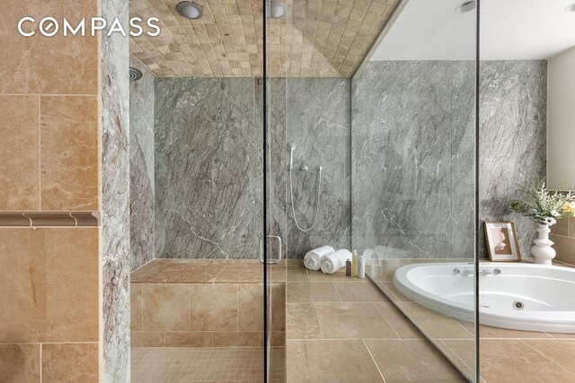 114 Liberty St Unit 7, New York City, NY 10006 - full bathroom with a shower stall, a jetted tub, and tile walls