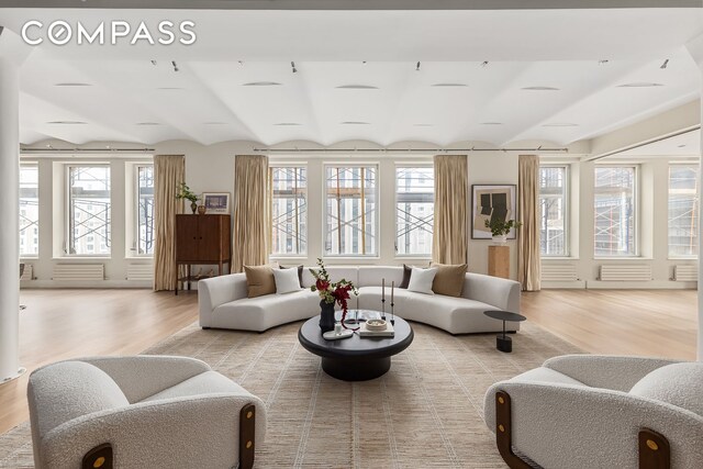 114 Liberty St Unit 7, New York City, NY 10006 - living area with light wood-style floors and vaulted ceiling