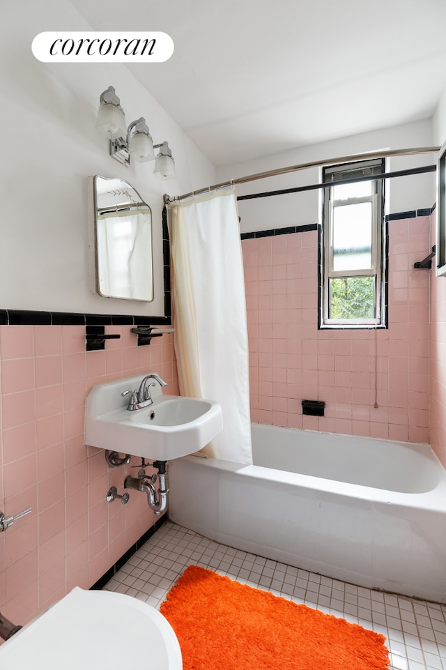 4 Bogardus Pl Unit 3E, New York City, NY 10040 - full bath with tile patterned floors, tile walls, shower / bathtub combination with curtain, a sink, and toilet