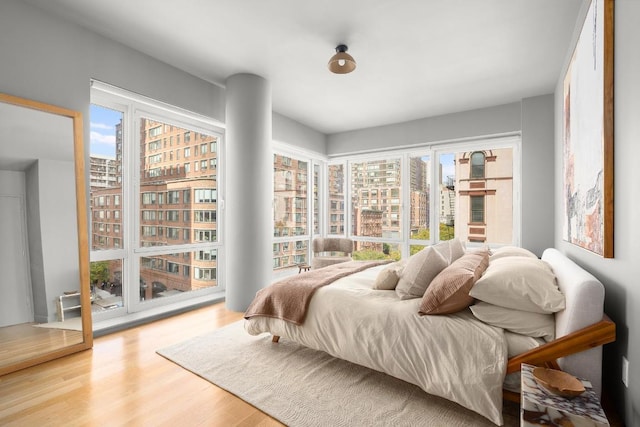 bedroom featuring hardwood / wood-style floors and multiple windows