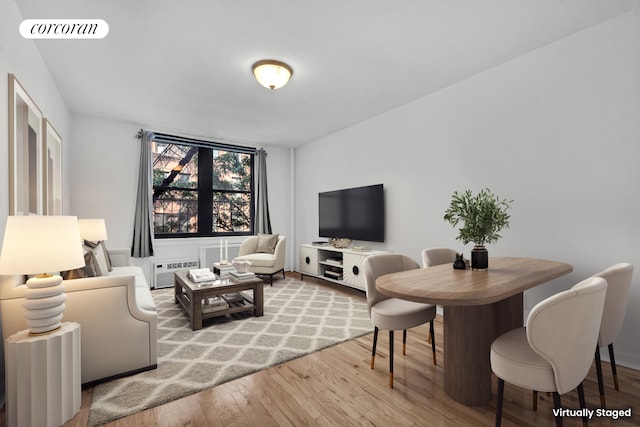 living area with visible vents, wood-type flooring, and a wall mounted AC