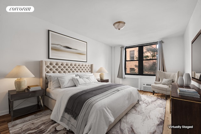 bedroom featuring visible vents and wood finished floors