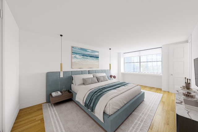 bedroom featuring light wood-type flooring and baseboards