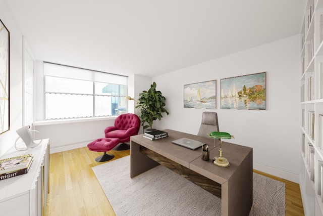 office space featuring baseboards and light wood-type flooring