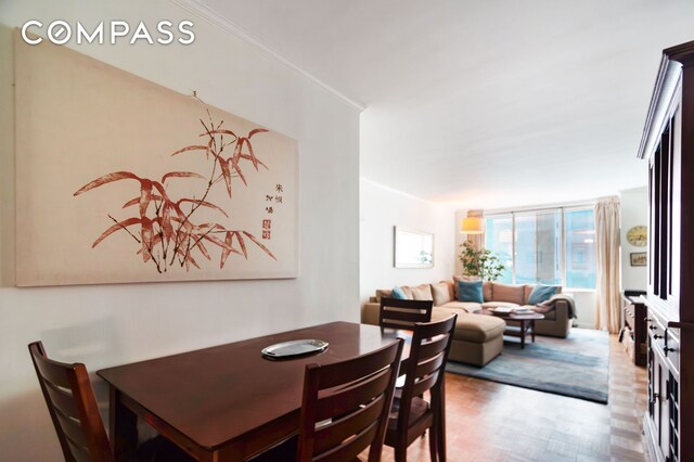 dining area featuring light parquet flooring and a wall of windows