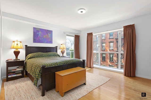 bedroom with baseboards and wood finished floors