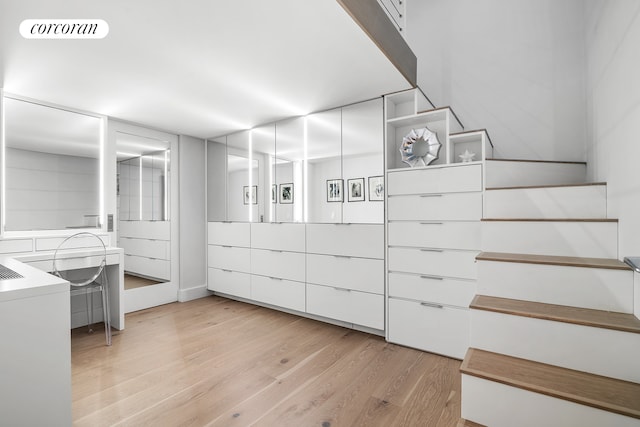 walk in closet featuring light wood-type flooring and visible vents