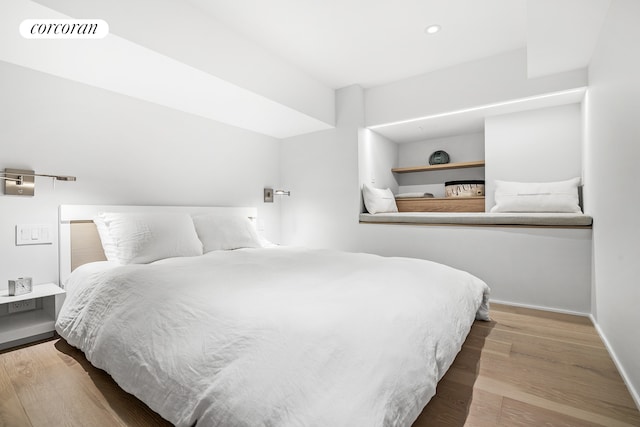 bedroom with visible vents, recessed lighting, baseboards, and wood finished floors