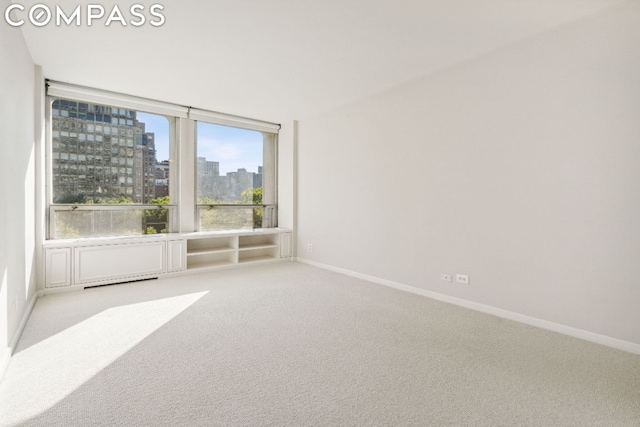 empty room with light colored carpet