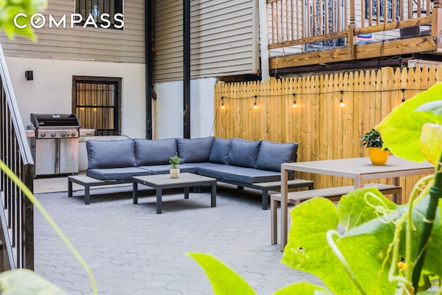 view of patio / terrace featuring a grill, an outdoor living space, and fence