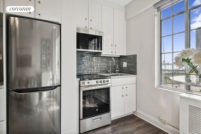 kitchen featuring a sink, stainless steel appliances, tasteful backsplash, and a healthy amount of sunlight