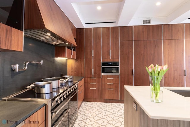 kitchen featuring stainless steel appliances and custom exhaust hood