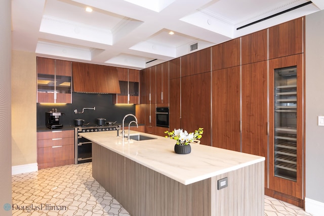 kitchen featuring visible vents, oven, a sink, stainless steel stove, and modern cabinets