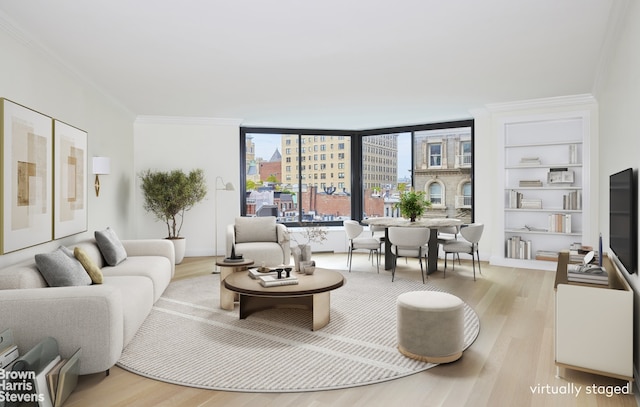 living room featuring crown molding and light hardwood / wood-style flooring