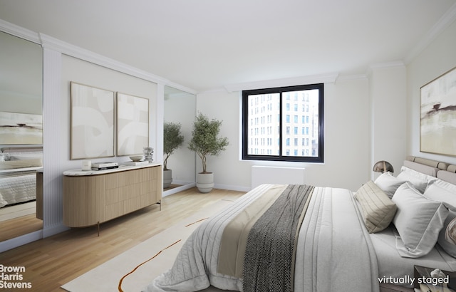 bedroom with light hardwood / wood-style flooring and ornamental molding