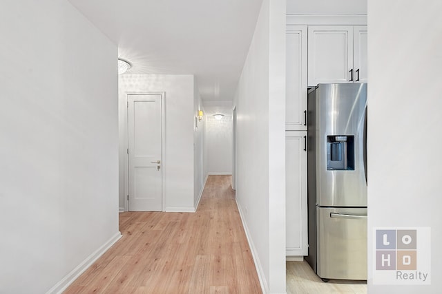 hallway with baseboards and light wood finished floors