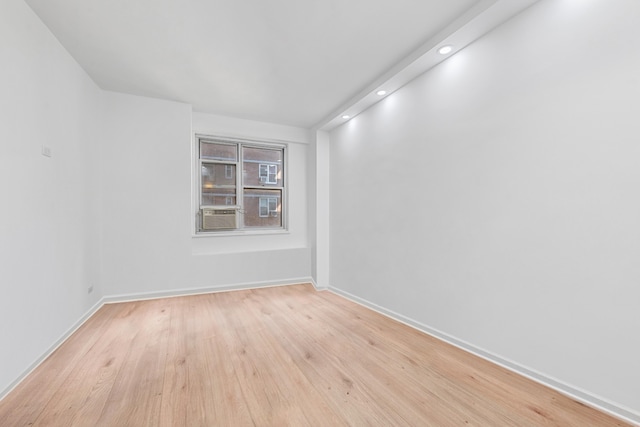 empty room featuring recessed lighting, light wood-style flooring, and baseboards