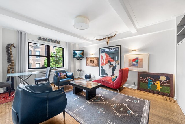 living room featuring beamed ceiling and hardwood / wood-style flooring