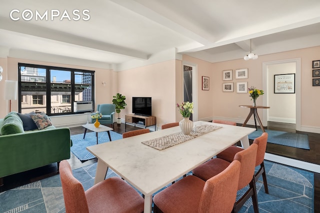 dining room featuring dark wood-type flooring, beamed ceiling, cooling unit, and baseboards