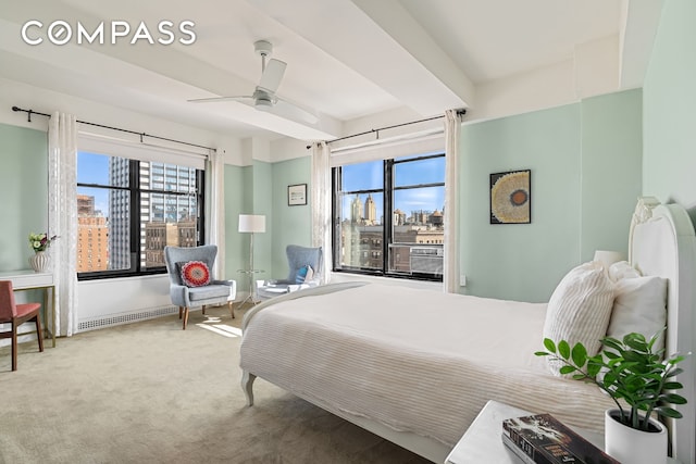 carpeted bedroom with beam ceiling, multiple windows, cooling unit, and ceiling fan