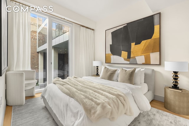 101 W 14th St Unit 3D, New York City, NY 10011 - bedroom with wood finished floors and access to exterior
