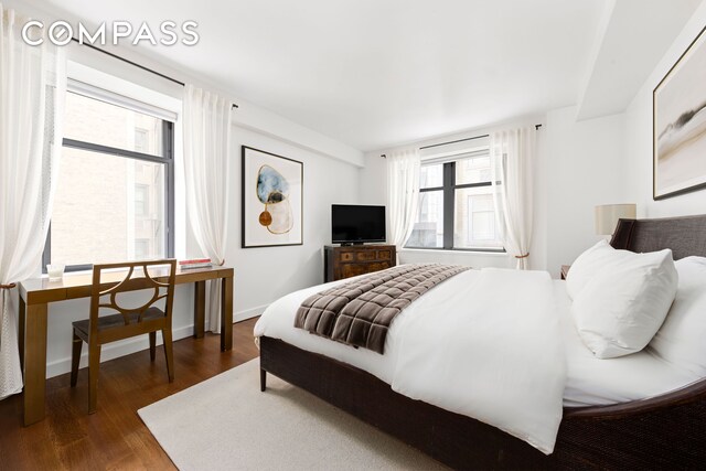 bedroom with dark wood-type flooring