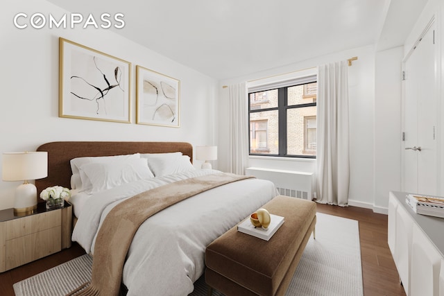 bedroom with dark wood-style floors