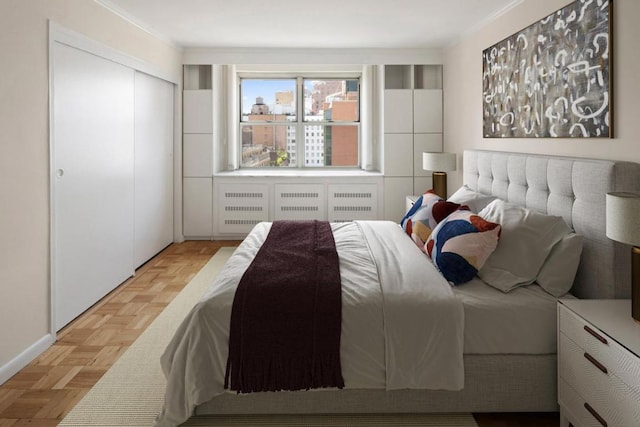 bedroom featuring light parquet flooring and a closet