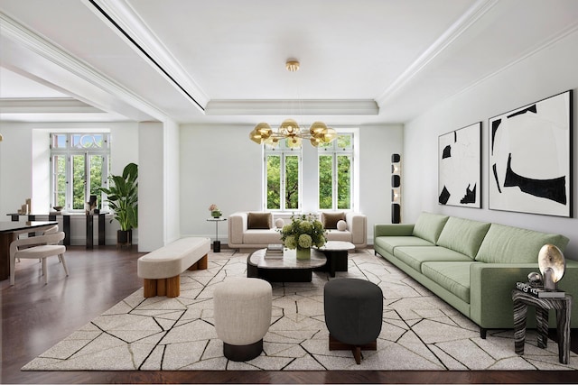 living area with a chandelier, a tray ceiling, ornamental molding, and baseboards