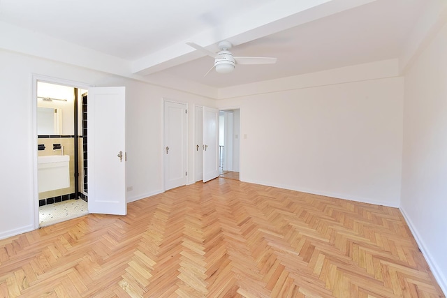 unfurnished bedroom with ensuite bath, baseboards, and ceiling fan