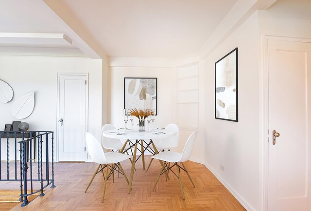 bedroom with ceiling fan and light parquet floors