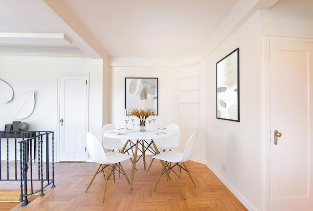 dining area featuring parquet flooring