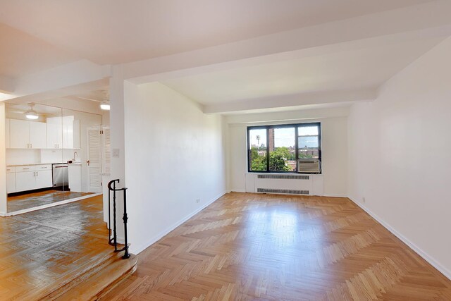 spare room featuring radiator heating unit and baseboards