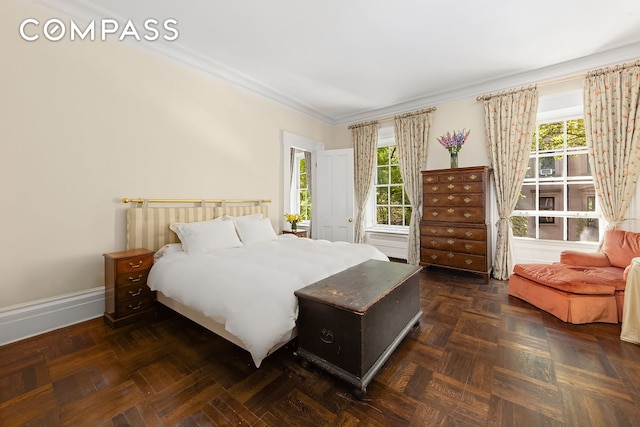 bedroom with baseboards, multiple windows, and crown molding