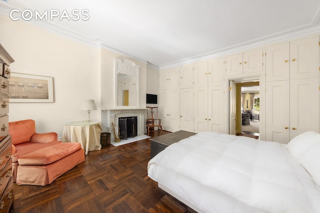 bedroom featuring a fireplace and crown molding