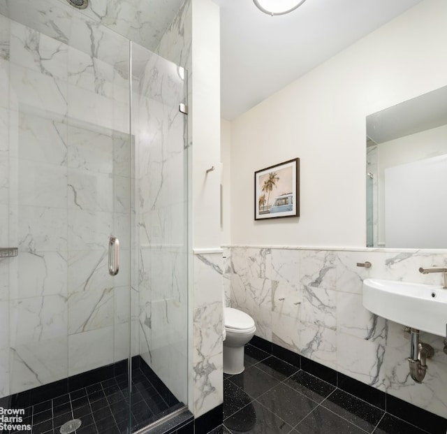 bathroom featuring toilet, tile walls, tile patterned floors, sink, and a shower with door