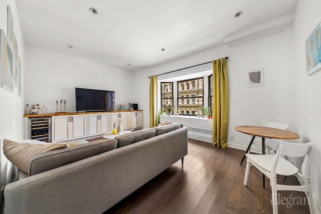 living room featuring wine cooler, bar area, and dark hardwood / wood-style floors