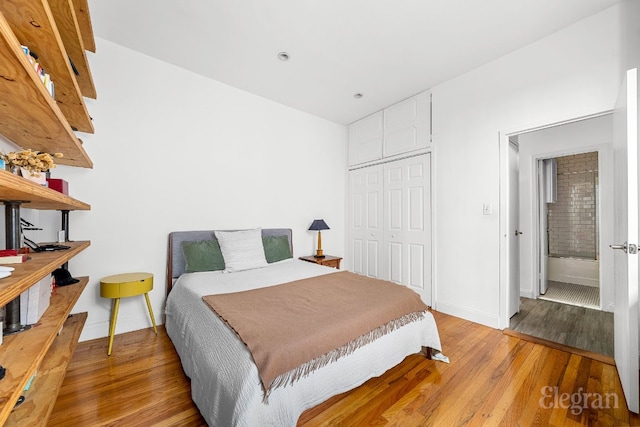 bedroom featuring hardwood / wood-style floors and a closet