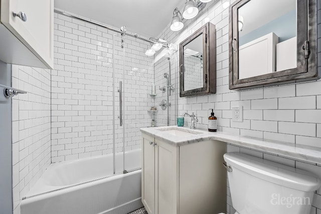 full bathroom with toilet, tasteful backsplash, bath / shower combo with glass door, tile walls, and vanity