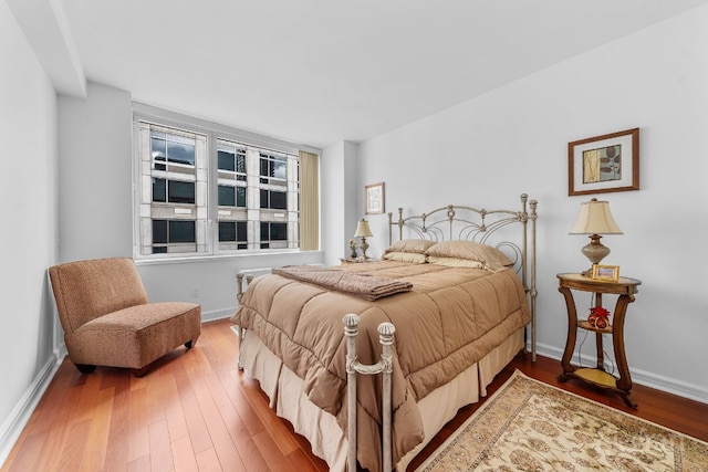 bedroom with hardwood / wood-style floors