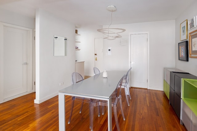 dining space with dark hardwood / wood-style flooring