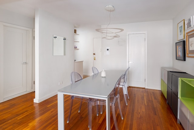 dining area with dark wood finished floors and baseboards