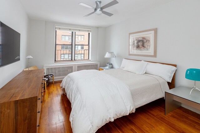 bedroom featuring radiator, ceiling fan, and dark hardwood / wood-style flooring