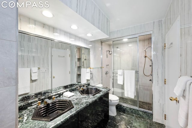 bathroom featuring toilet, tile walls, sink, and a shower with door