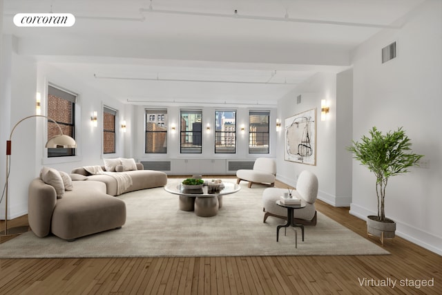 interior space featuring wood finished floors, visible vents, and baseboards