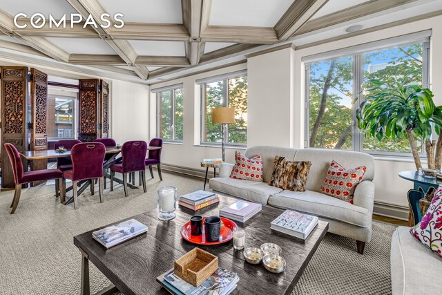 living room with coffered ceiling, beam ceiling, and baseboard heating